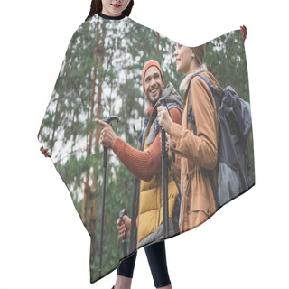 Personality  Happy Man Pointing Away With Finger While Looking At Girlfriend With Hiking Sticks In Forest  Hair Cutting Cape