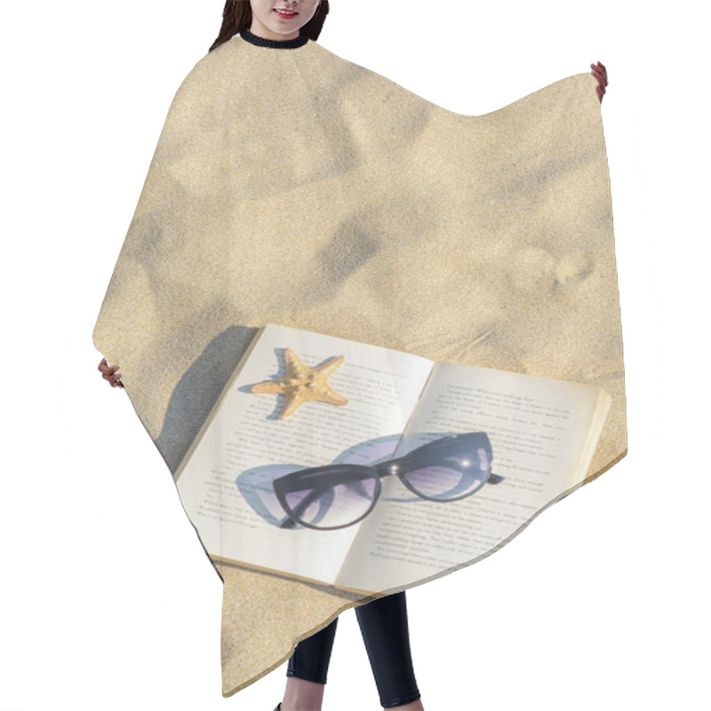 Personality  Beautiful Sunglasses, Book And Starfish On Sand, Top View. Space For Text Hair Cutting Cape