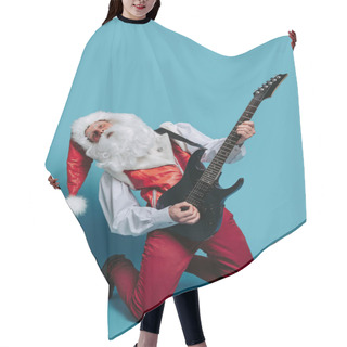 Personality  Full Size Of Cool Emotional Santa Claus Rock Musician Who Play On Electric Guitar On Blue Studio Background. Christmas And New Year Party. Hair Cutting Cape