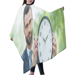 Personality  Panoramic Shot Of Young Man Holding Clock And Looking At Camera Hair Cutting Cape