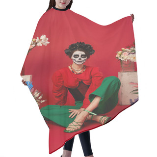 Personality  Woman In Catrina Makeup Sitting Near Traditional Dia De Los Muertos Ofrenda With Flowers On Red Hair Cutting Cape