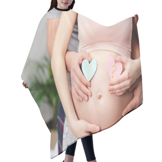 Personality  Cropped Shot Of Man Hugging Pregnant Woman And Holding Blue And Pink Hearts With Question Marks Hair Cutting Cape
