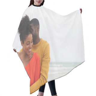 Personality  Front View Of Happy Multi-ethnic Couple Standing At Beach On A Sunny Day. Man Hiding Face Behind Woman Hair Cutting Cape