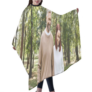 Personality  A Man And A Woman In Casual Attire Stroll Through A Lush Forest. Hair Cutting Cape