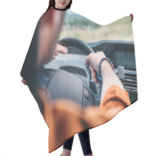 Personality  Cropped Image Of Man Sitting Behind His Car Wheel  Hair Cutting Cape