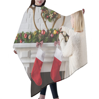 Personality  Young Woman Adjusting Christmas Baubles At Fireplace Hair Cutting Cape