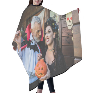 Personality  Woman With Halloween Pumpkin Grimacing Near Husband With Paper Cut Bat Hair Cutting Cape