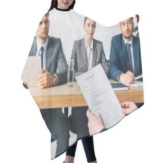 Personality  Selective Focus Of Employee Holding Resume Near Recruiters At Table In Office  Hair Cutting Cape