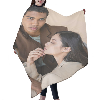 Personality  Stylish African American Guy With Piercing Looking At Camera Near Young Asian Woman With Closed Eyes Isolated On Beige Hair Cutting Cape