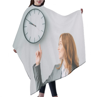 Personality  Smiling Redhead Businesswoman Pointing With Finger And Looking At Wall Clock On Grey Hair Cutting Cape