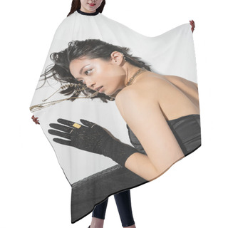 Personality  Overhead View Of Asian Model With Short Brunette Hair Holding Golden Jewelry In Mouth While Looking Away And Lying On Grey Background,  Wet Hairstyle, Young Woman, Black Gloves Hair Cutting Cape