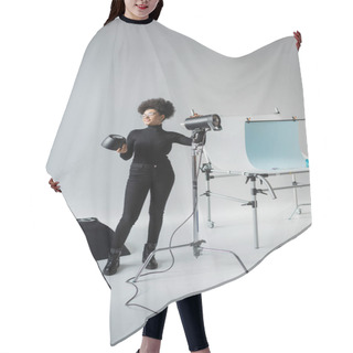 Personality  Full Length Of Cheerful African American Content Producer Assembling Lighting Equipment Near Shooting Table In Photo Studio Hair Cutting Cape