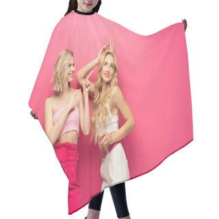 Personality  Smiling Girl Pointing With Fingers At Attractive Blonde Friend In Crown On Pink Background Hair Cutting Cape