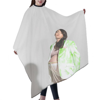 Personality  Stylish Pregnant Woman With Wavy Brunette Hair Looking At Camera While Posing In Green And White Blazer, Crop Top, Leggings And Beads Belt On Grey Background, Expectation, Maternity Fashion Concept Hair Cutting Cape