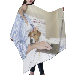 Personality  Close Up Shot Of Young Woman Working Remotely From Home In Her Bed On Laptop Due To Coronavirus Quarantine. Freelancer Female With Her Jack Russell Terrier Puppy. Copy Space, Background, Hair Cutting Cape