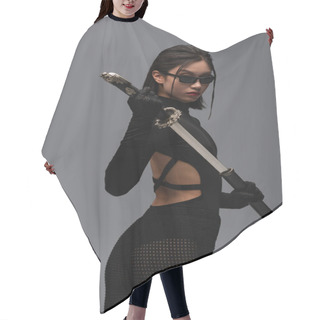 Personality  Dangerous Asian Woman In Black Outfit And Stylish Sunglasses Pulling Out Katana From Scabbard Isolated On Grey Hair Cutting Cape