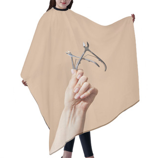 Personality  Cropped View Of Female Hand With Cuticle Nippers Isolated On Beige Hair Cutting Cape