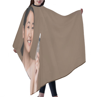 Personality  Smiling Asian Model With Naked Shoulders Holding Cosmetic Serum Isolated On Brown, Banner  Hair Cutting Cape