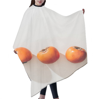 Personality  Top View Of Three Ripe Persimmons On White Hair Cutting Cape