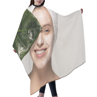 Personality  Happy Young Woman With Cosmetic Mask On Face And Towel On Head Posing With Green Leaf, Isolated On Grey  Hair Cutting Cape
