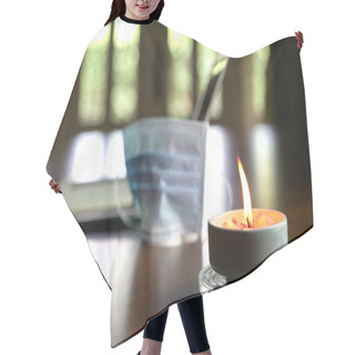 Personality  Work At Home During Coronavirus Outbreak. Focus On Burning Candle On Table With Face Mask And Laptop At The Background. Copy Space. Hair Cutting Cape