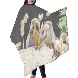 Personality  Selective Focus Of Toy Dinosaurs Standing Near Caves And Plants On Sand Dune  Hair Cutting Cape