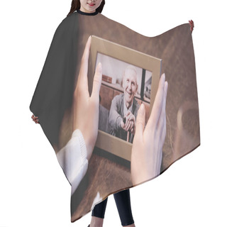 Personality  Partial View Of Female Hands Holding Photo Frame With Picture Of Elderly Man At Home Hair Cutting Cape