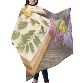 Personality  Composition With Flowers And Dry Up Plants On Notebooks On Table Close Up Hair Cutting Cape