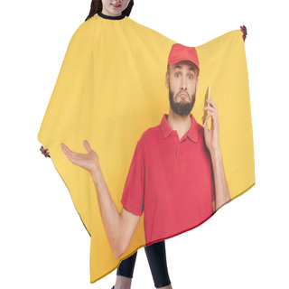 Personality  Confused Bearded Delivery Man In Red Uniform Talking On Smartphone On Yellow Hair Cutting Cape