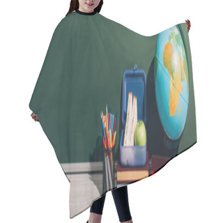 Personality  Horizontal Image Of Globe Near Lunch Box On Books And Pen Holder Near Green Chalkboard Hair Cutting Cape