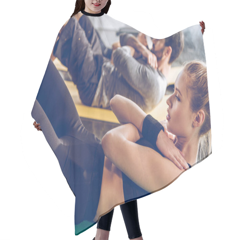 Personality  Athletic young people exercising in gym  hair cutting cape