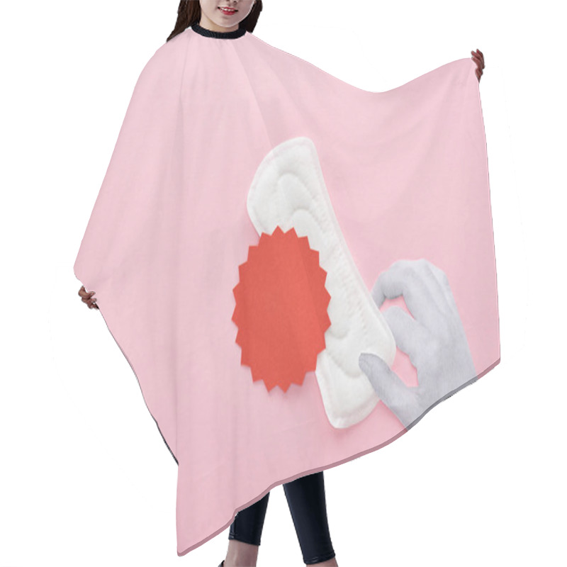 Personality  Cropped View Of Hand Holding White Sanitary Napkin With Blood Sign On Pink Background Hair Cutting Cape
