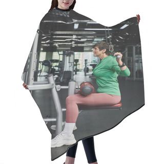 Personality  Strong And Motivated Elderly Woman Working Out In Gym, Mature Fitness, Exercise Machine, Side View Hair Cutting Cape