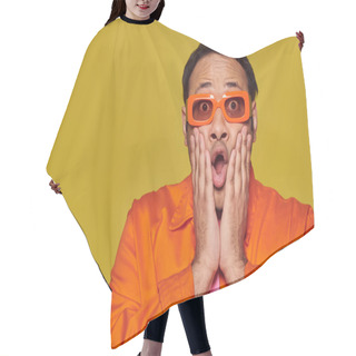 Personality  Expressive, Shocked Indian Man In Orange Sunglasses Touching Face And Saying Wow On Yellow Backdrop Hair Cutting Cape
