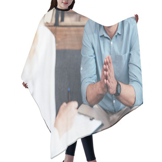Personality  Cropped Image Of Female Counselor Writing In Clipboard And Smiling Male Holding Hand Palms Together During Therapy Session In Office  Hair Cutting Cape