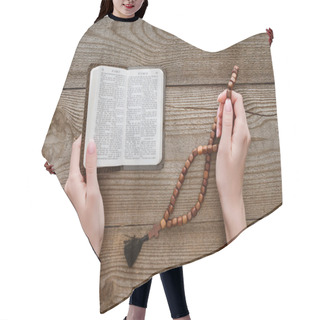 Personality  Cropped Shot Of Woman With Holy Bible Holding Beads On Wooden Surface Hair Cutting Cape