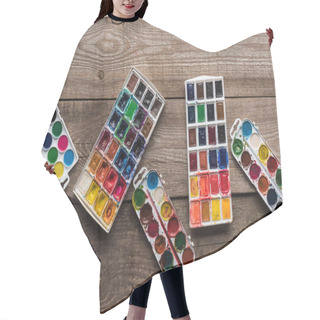 Personality  Top View Of Watercolor Paint Palettes On Wooden Brown Surface  Hair Cutting Cape