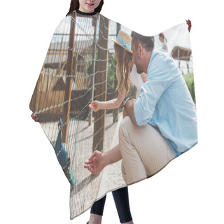 Personality  Father And Daughter Gesturing Near Cage With Peacock In Zoo  Hair Cutting Cape