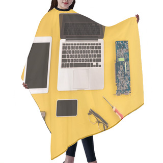 Personality  Top View Of Digital Devices With Black Screens And Motherboard And Hardware On Yellow Hair Cutting Cape