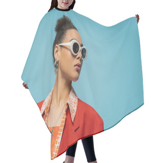 Personality  Portrait Of African American Woman In Hoop Earrings, Sunglasses And Vibrant Outfit Posing On Blue Hair Cutting Cape