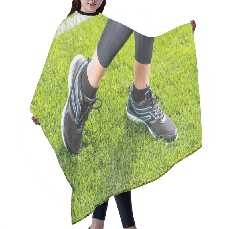 Personality  Sportswoman standing on grass  hair cutting cape