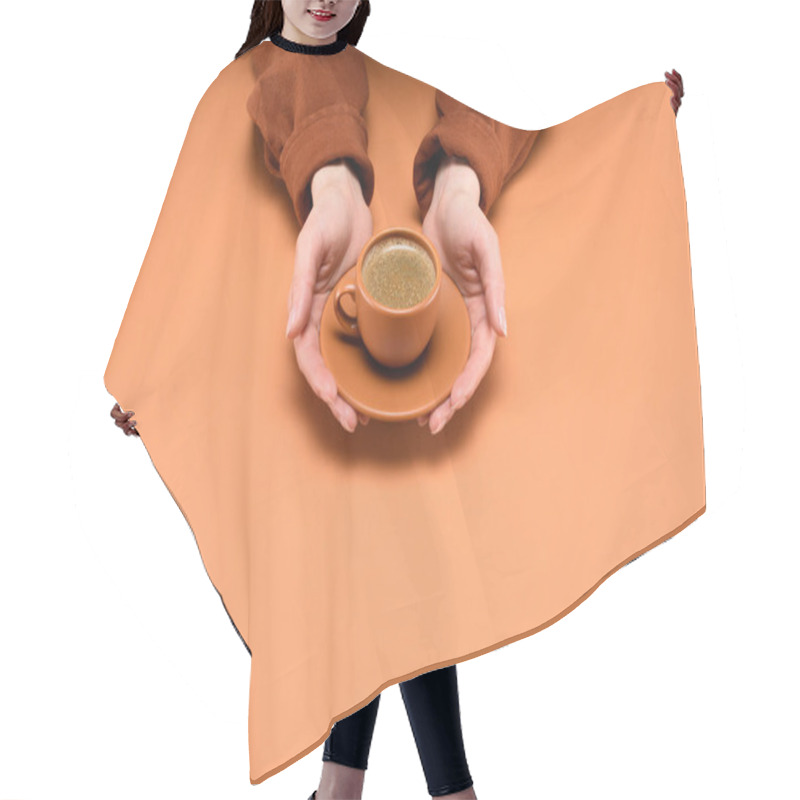 Personality  Cropped Shot Of Woman Holding Cup Of Coffee On Saucer In Hands Isolated On Peach Hair Cutting Cape
