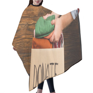 Personality  Cropped View Of Man Putting Clothes In Cardboard Box With Donate Lettering On Wooden Background, Charity Concept Hair Cutting Cape