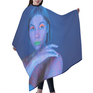Personality  Nude Woman In Vibrant Body Paint And Neon Makeup Looking At Camera Isolated On Dark Blue Hair Cutting Cape