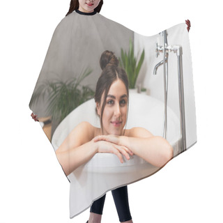 Personality  Joyful Young Woman With Hair Bun Looking At Camera In Bathtub  Hair Cutting Cape
