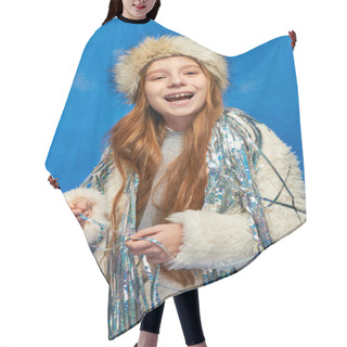Personality  Smiling Girl In Faux Fur Jacket And Hat With Tinsel Standing Under Falling Snow On Blue Backdrop Hair Cutting Cape