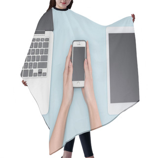 Personality  Top View Of Woman Holding Smartphone Near Gadgets On Light Blue Background  Hair Cutting Cape
