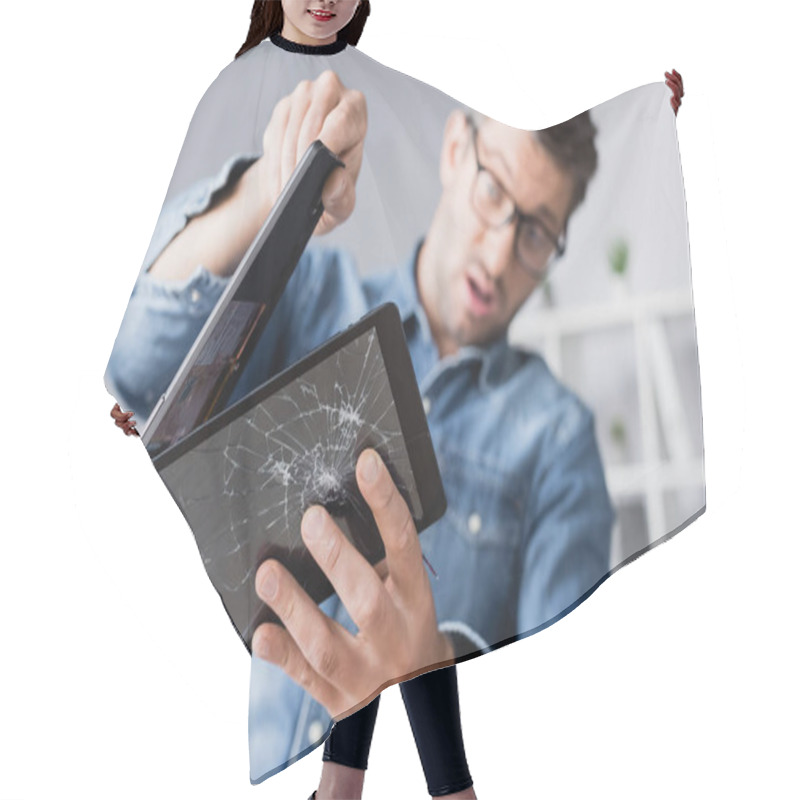 Personality  Surprised businessman disassembling smashed digital tablet on blurred background hair cutting cape