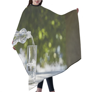 Personality  Cropped View Of Woman Pouring Fresh Clean Water From Bottle In Transparent Glass At Sunny Day On Wooden Table Hair Cutting Cape