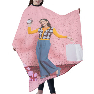 Personality  Joyful And Fashionable Woman Posing With Alarm Clock And Shopping Bags Near Confetti And Gift Boxes On Pink Background Hair Cutting Cape